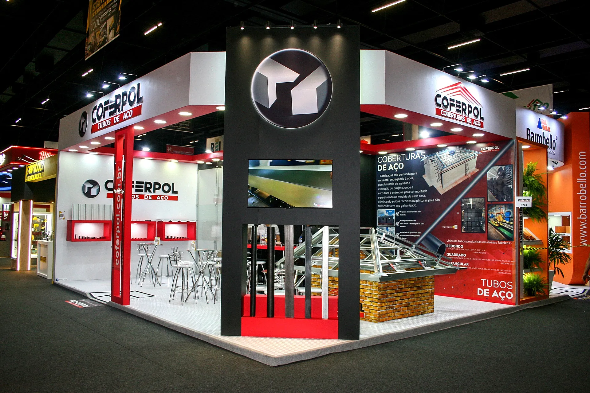 Stand da Coferpol na Feicon 2025, com torre central preta, televisor e amostras de tubos de aço e coberturas metálicas.